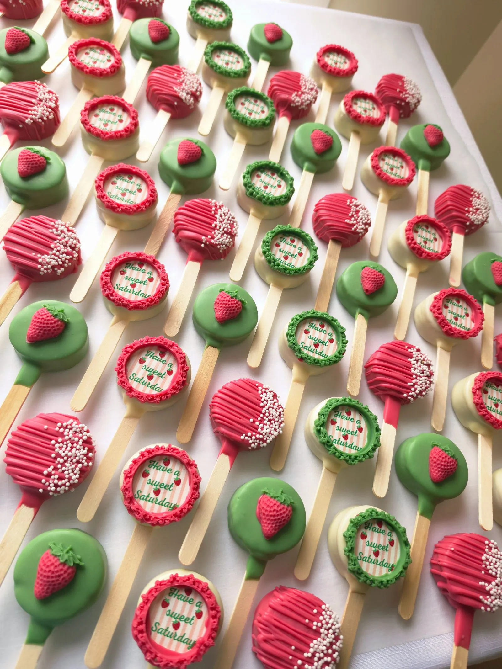 An arrangement of handcrafted cakesicles finished with satin bows